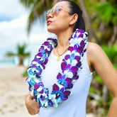 Ocean Breeze Blue, Purple & White Orchid Lei – A luxurious double-strand floral garland made with 100 fresh orchids. Flown from Thailand, this handcrafted lei is ideal for Hawaiian luaus, graduation ceremonies, tropical weddings, and summer parties. With vibrant colors, premium quality, and elegant design, this floral necklace is a top seller for those seeking a unique and stylish accessory for any celebration.