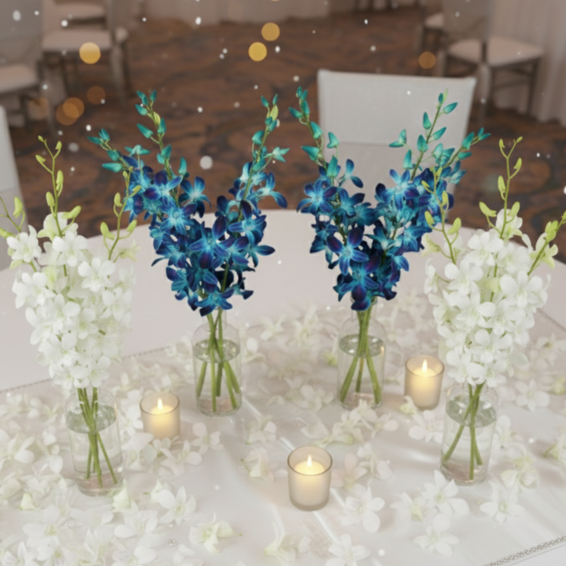 Holiday and New Year party table decorated with blue and white dendrobium orchids and loose white orchid blooms.