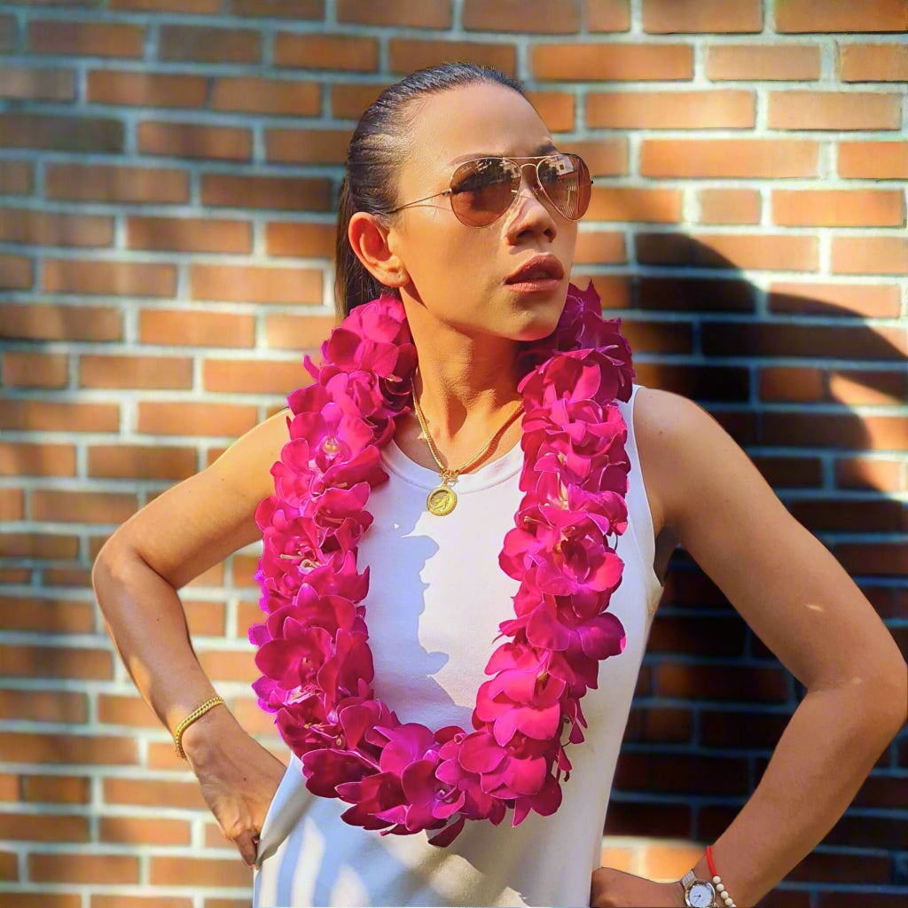 The Red Bull Double Orchid Lei combines the beauty of deep red and dark purple orchids, handwoven into a full, luxurious design. This lei is perfect for those looking for a bold floral accessory that exudes power and elegance. Whether celebrating a special event, honoring a loved one, or embracing the spirit of aloha, this fresh Thai orchid lei is the ideal choice for unforgettable tropical celebrations.