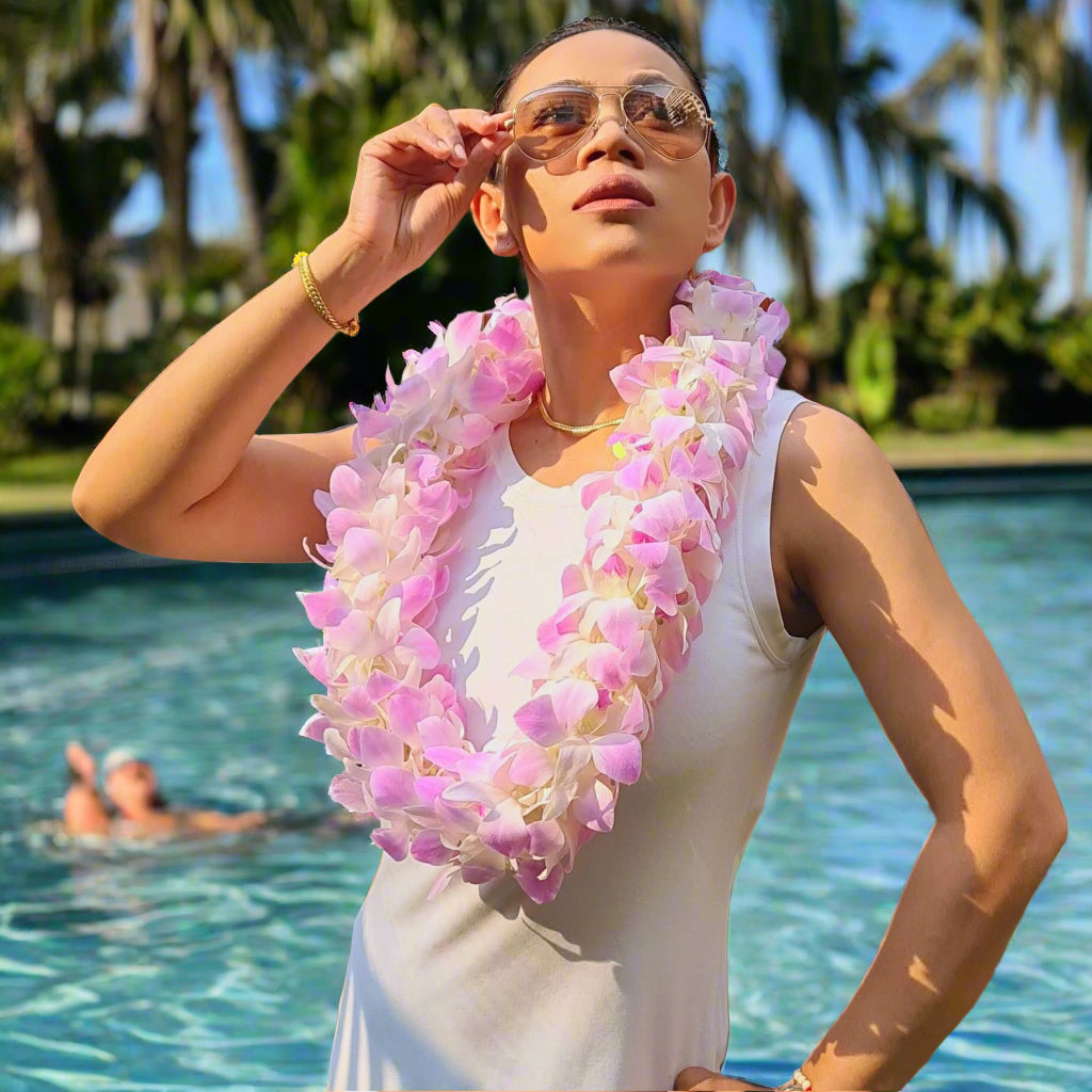 Designed for those who appreciate elegance, the Pink Blush Double Orchid Lei is meticulously crafted using over 100 premium pink and white orchids. Each flower is expertly arranged in a double-strand formation to create a voluminous and eye-catching floral necklace. Whether you're celebrating a wedding, attending a tropical luau, or gifting a loved one, this lei’s fresh, delicate orchids make it the perfect accessory for any event.