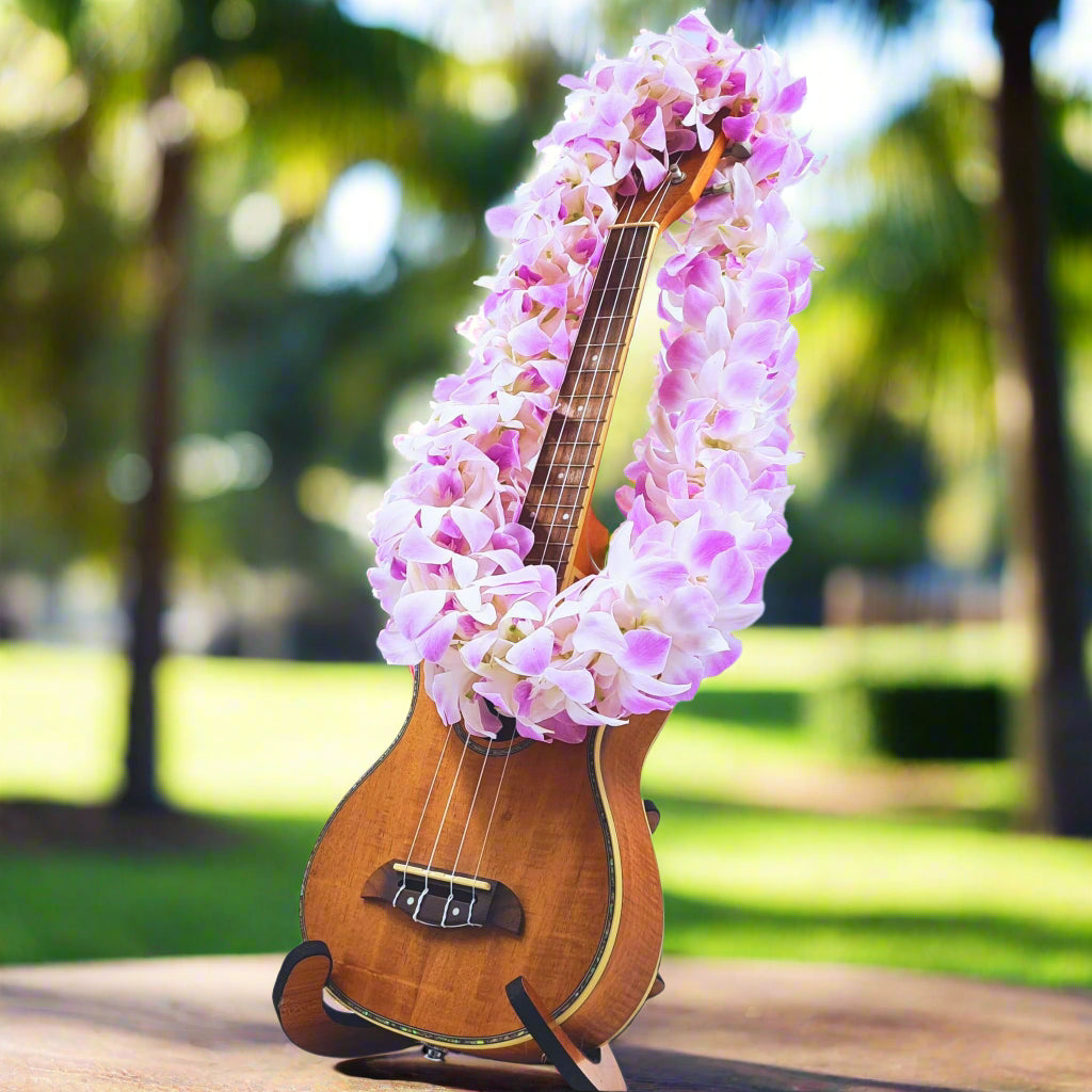 Featuring a double strand of fresh orchids, the Pink Blush Lei blends pink and white flowers for a soft, elegant look. This lei is perfect for weddings, graduations, luaus, and tropical events, adding a beautiful and sophisticated floral accent. Handcrafted in Thailand and flown fresh to the USA, it offers a high-quality and vibrant accessory for your special day.