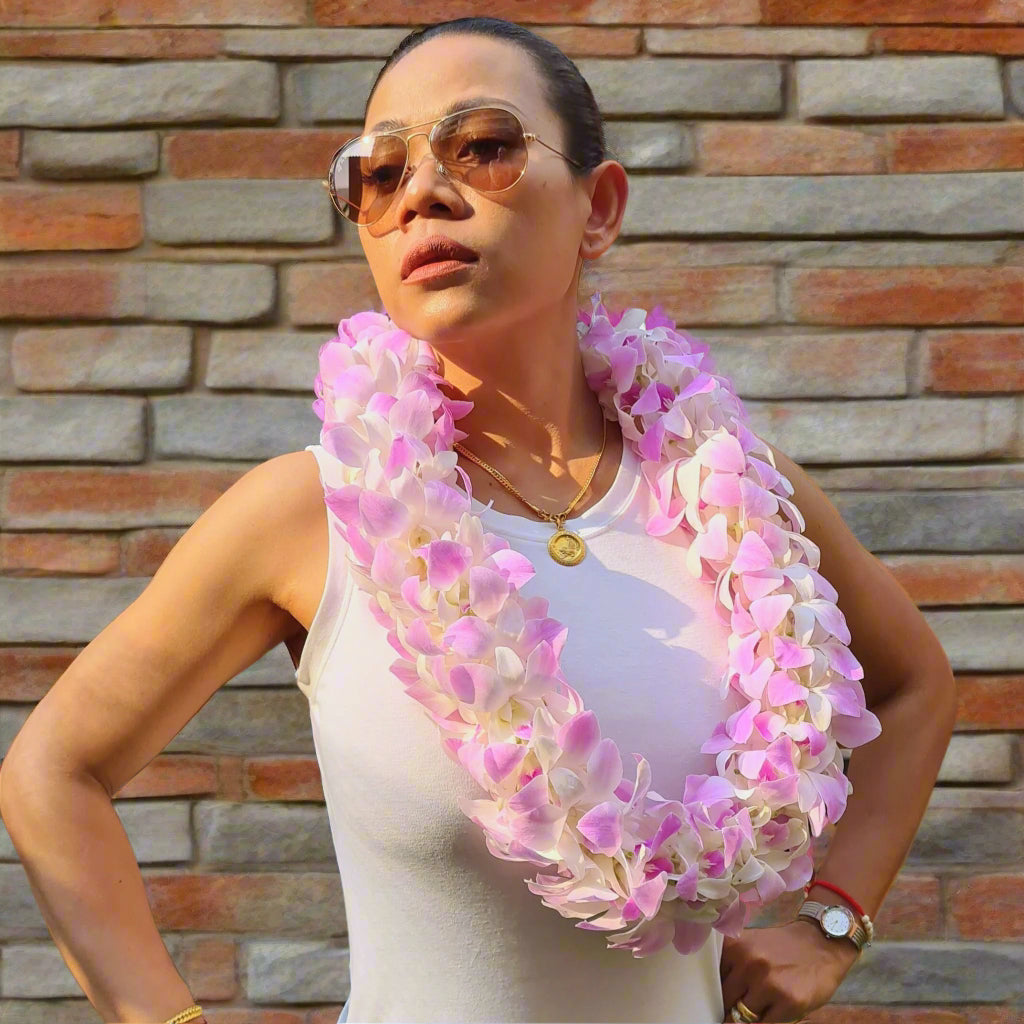 The Pink Blush Double Orchid Lei is an exquisite floral arrangement made from real Thai orchids in soft pink and white hues. Its double-strand design provides a rich, full appearance, creating a stunning visual effect. Carefully handcrafted, this lei is a breathtaking addition to Hawaiian-themed weddings, beach events, and island getaways. The fresh blooms maintain their vibrancy, ensuring a beautiful and long-lasting floral adornment.